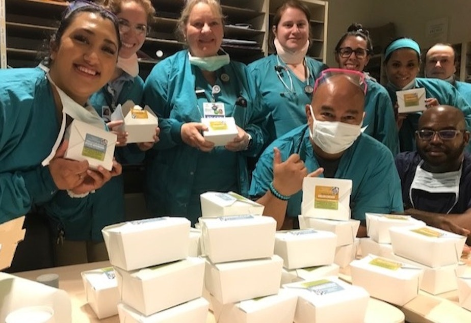caption: Grateful healthcare workers receive meals from The Herbfarm