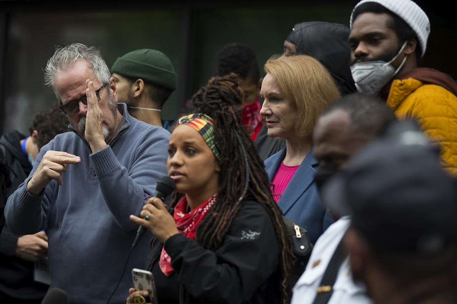 caption: Seattle Mayor Jenny Durkan stands between organizers Rashyla Levitt and David Lewis, right, on Tuesday, June 2, 2020, outside of the Emergency Operations Center in Seattle. Mayor Durkan promised a crowd of thousands that she would meet with organizers the following day. 