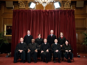 caption: A group photo of the justices at the Supreme Court in Washington on April 23, 2021. Seated from left: Samuel Alito, Clarence Thomas, John Roberts, Stephen Breyer and Sonia Sotomayor. Standing from left: Brett Kavanaugh, Elena Kagan, Neil Gorsuch and Amy Coney Barrett.