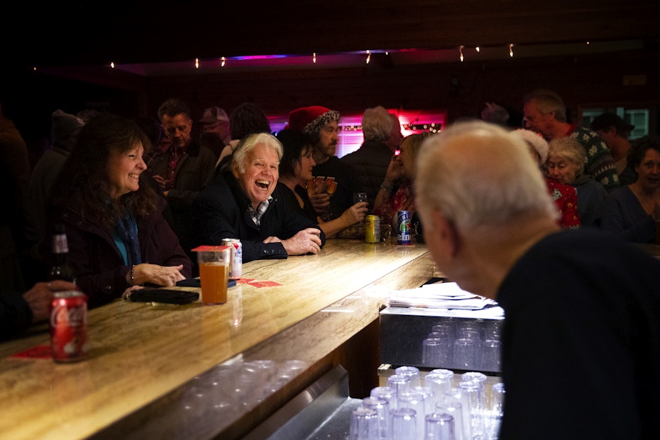 caption: Ron W. Bailey smiles and laughs with John Spaccarotelli, 94-year-old owner and bartender, on the last night of business for the Shanty Tavern on Friday, December 19, 2025, in Lake City.