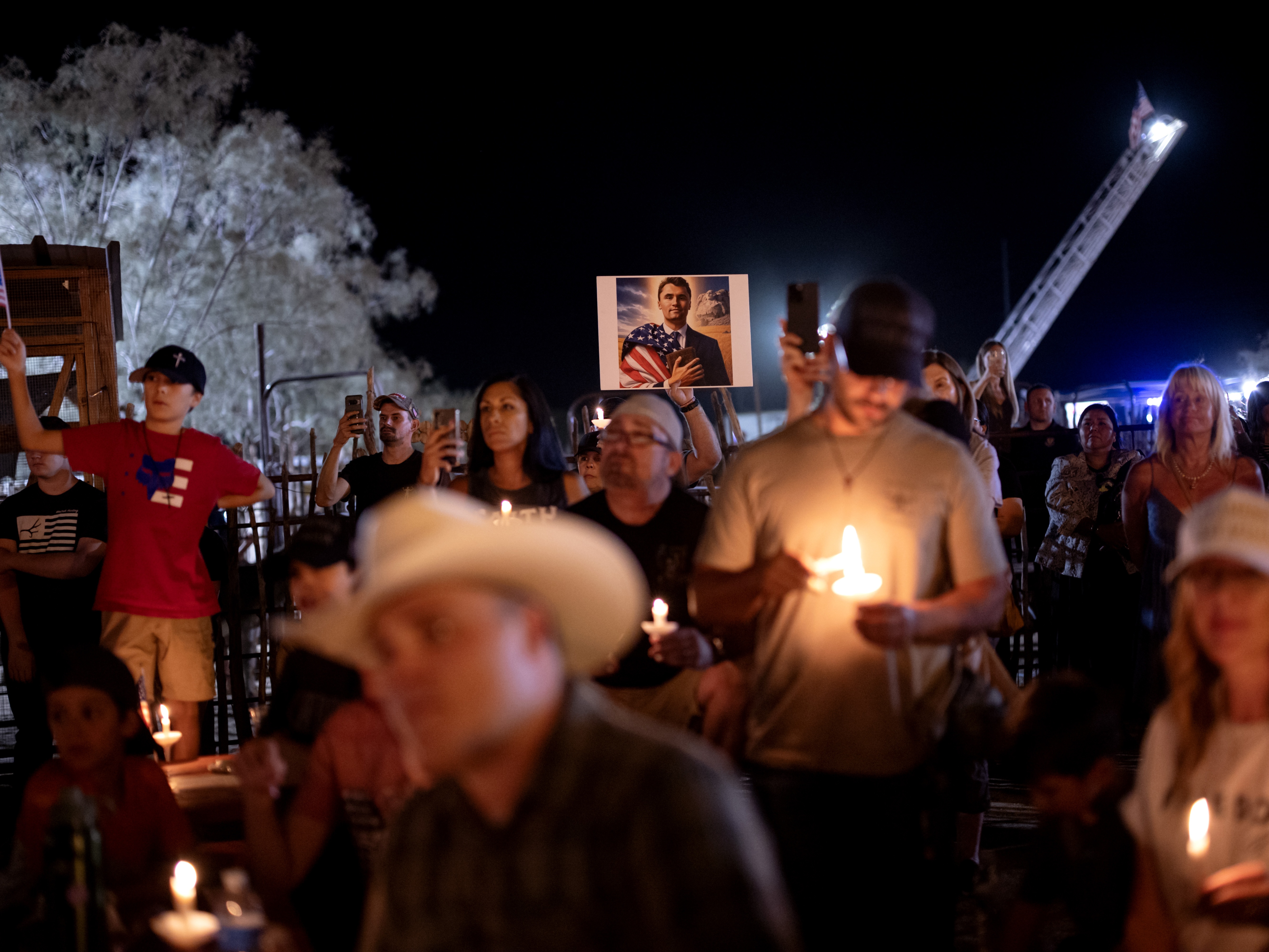 caption: People attend a vigil for Charlie Kirk at Western Trails Ranch in Morristown, Ariz., on Saturday.