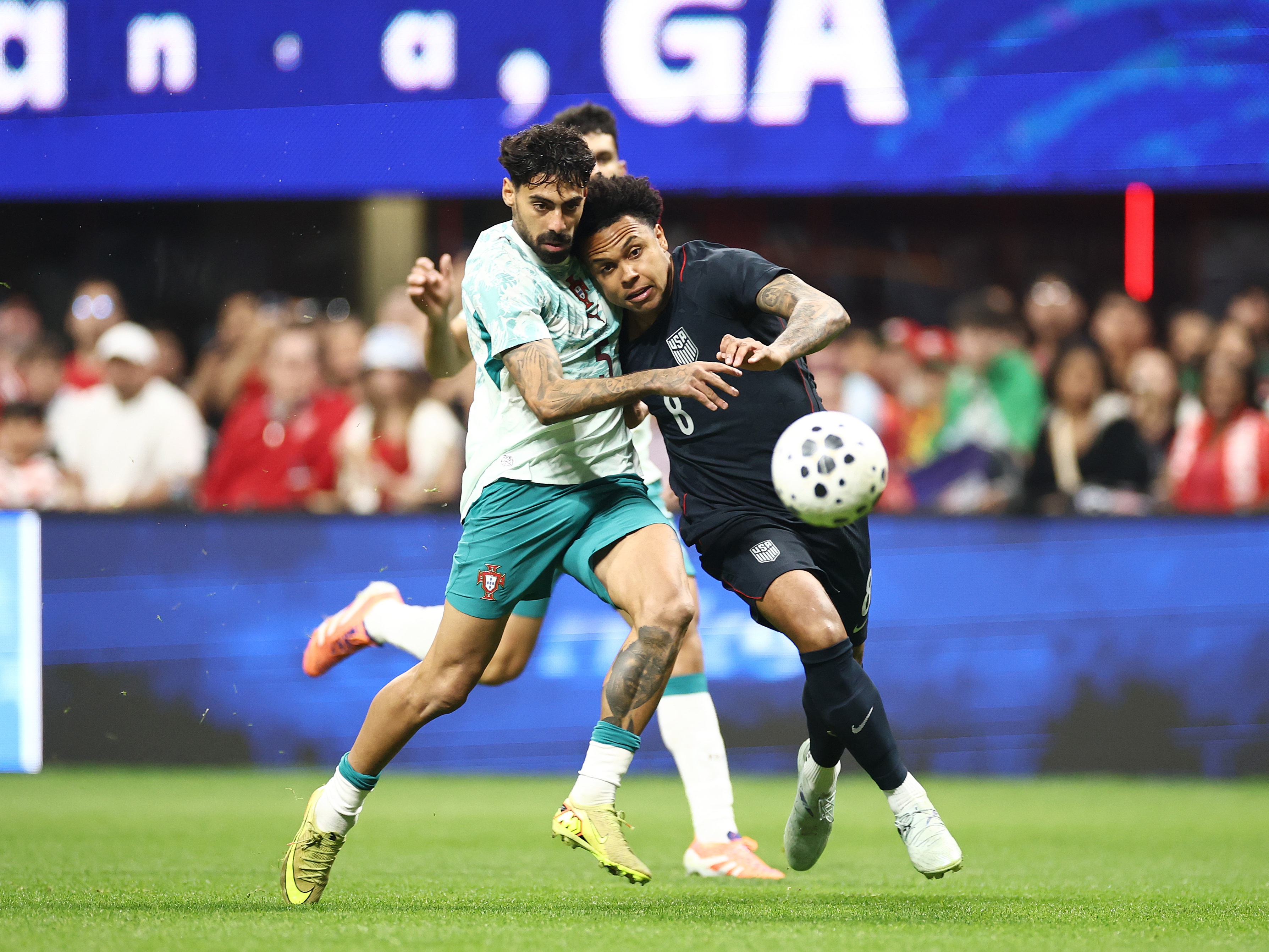 caption: Weston McKennie of the United States (right) and Samu Costa of Portugal compete for the ball during a match in Atlanta on Tuesday. Portugal defeated the U.S. 2-0, giving the USMNT another disappointing loss ahead of this summer's World Cup.