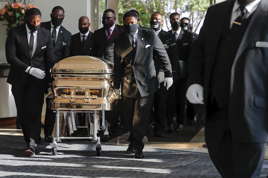 caption: Pallbearers bring the coffin into The Fountain of Praise church in Houston for the funeral for George Floyd on Tuesday, June 9, 2020. Floyd was killed by Minneapolis Police officers on May 25.