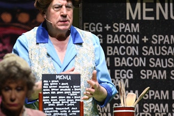 caption: Terry Jones performs the famous "Spam" sketch during 2014's <em>Monty Python Live (Mostly)</em> stage show.