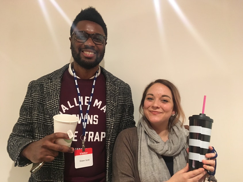 caption: Shaun Scott (nametag misspelled)  and Hanna Brooks Olsen, holding the coffees they chose to buy instead of putting down payments on a home. Michael Hobbes has a policy of keeping his face off of the internet. Overhead sparkles are complete happenstance.
