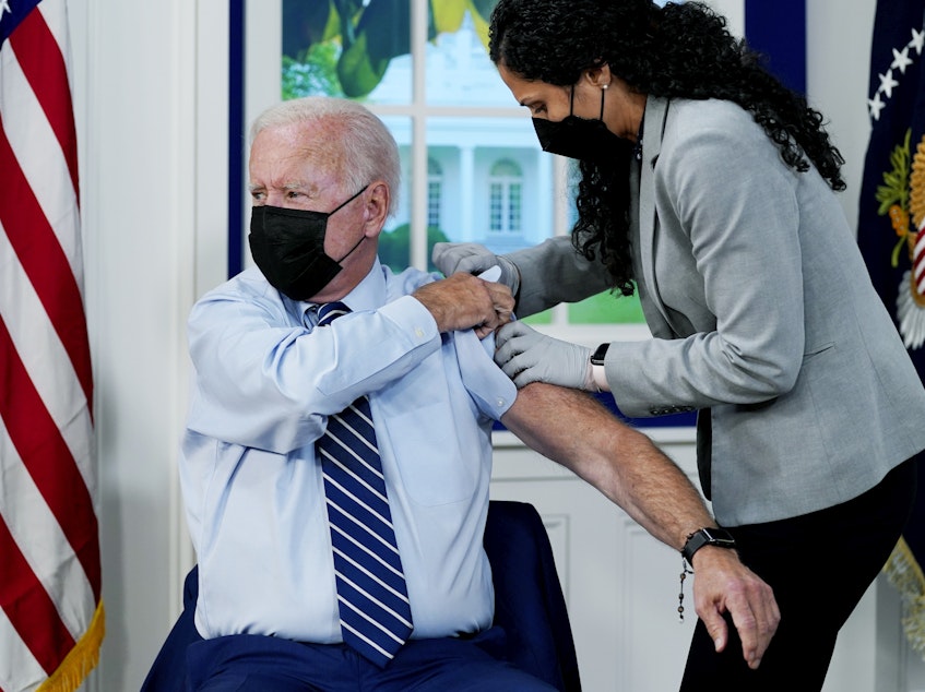 caption: President Joe Biden receives a COVID-19 booster shot during an event at the White House campus on Sept. 27.