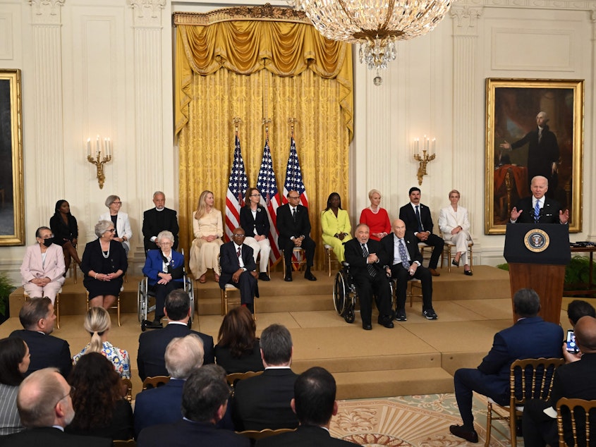 caption: President Joe Biden speaks before presenting the Presidential Medal of Freedom, the nation's highest civilian honor, during a ceremony honoring 17 recipients in the East Room of the White House on Thursday.