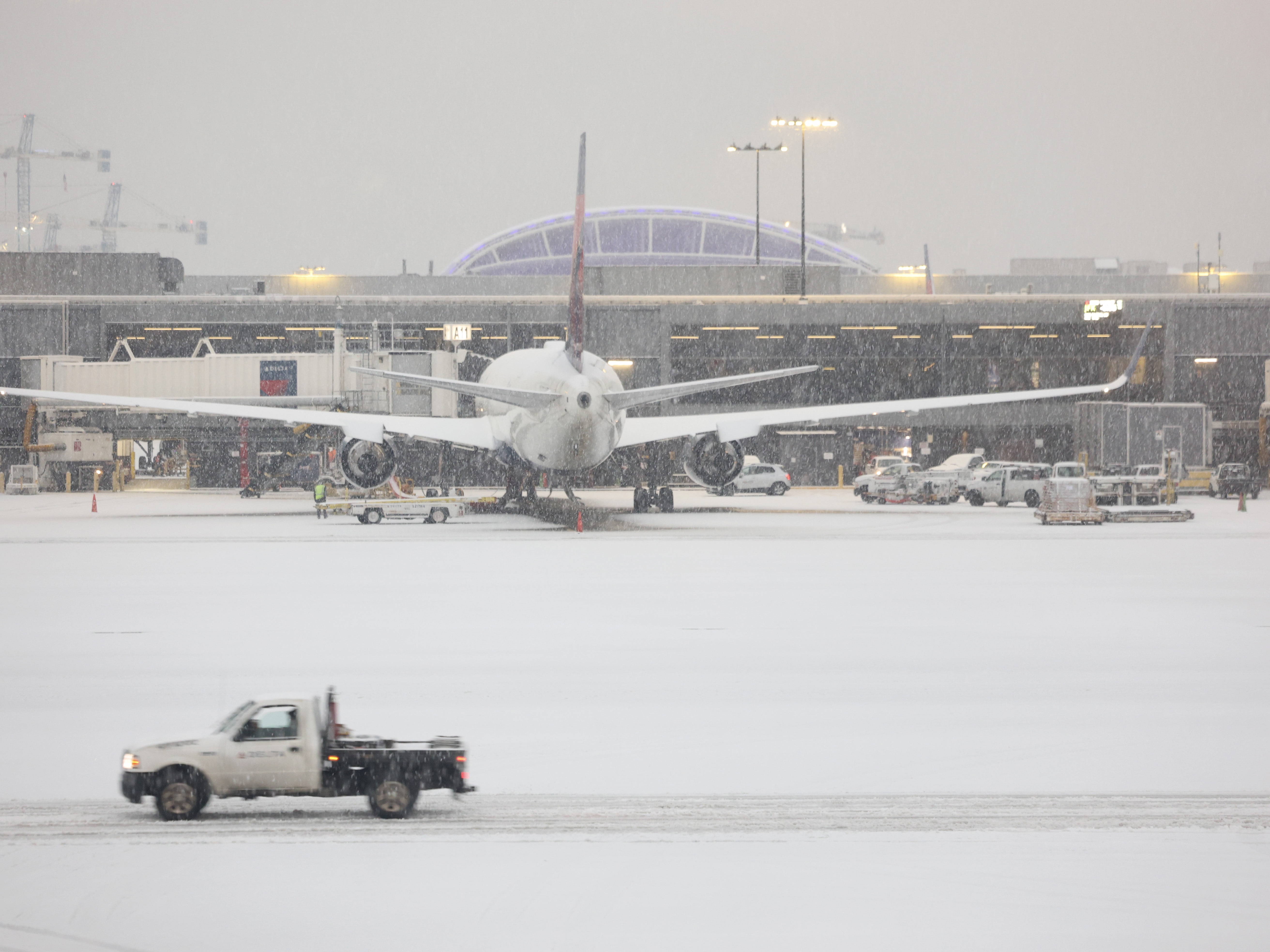 caption: Snow blankets the Hartsfield-Jackson Atlanta International Airport on Friday as a winter storm moves into the Atlanta area.