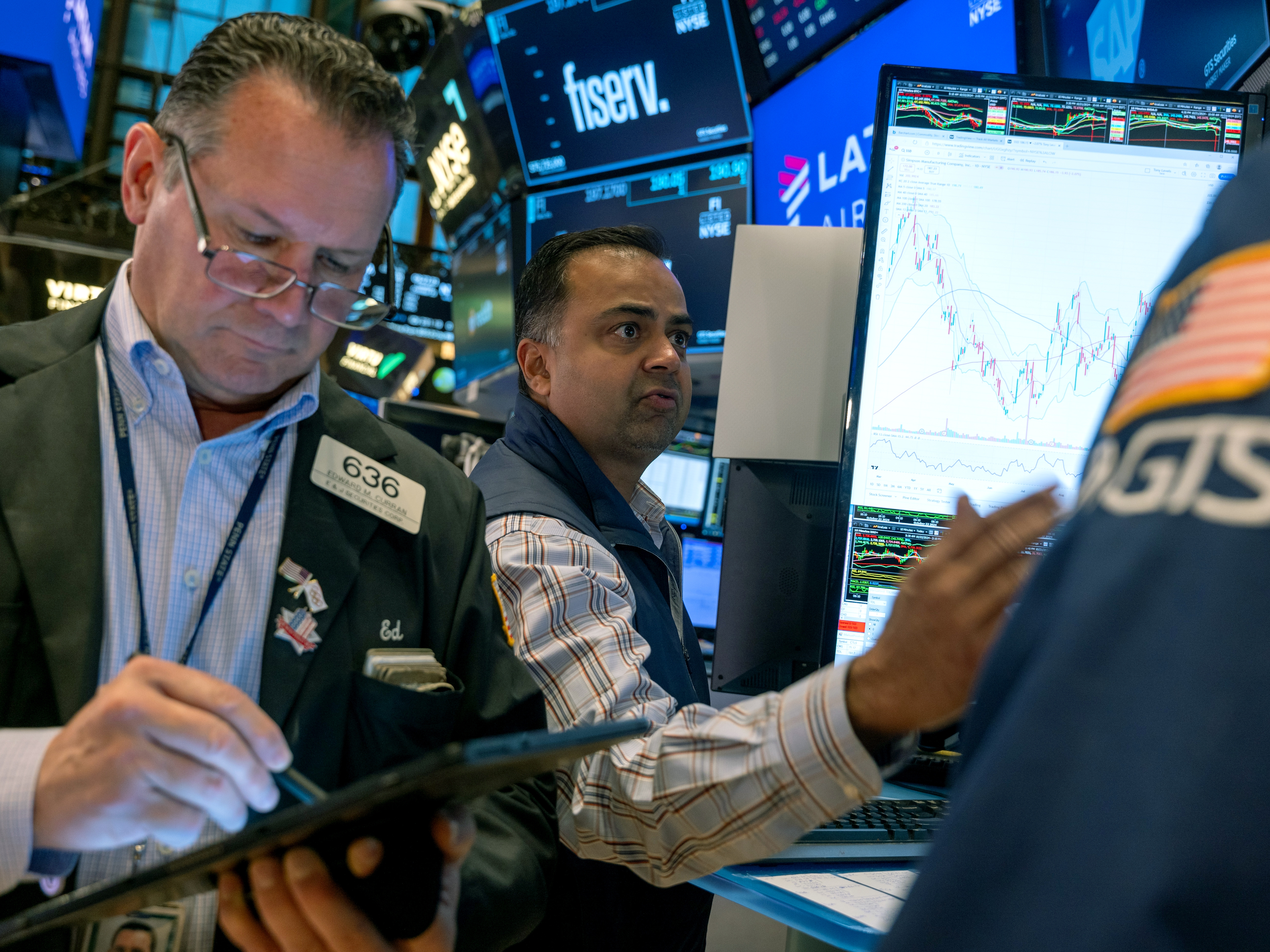 caption: Stocks and cryptocurrencies surged after former President Trump won the presidential election. Pictured are traders working on the New York Stock Exchange in New York on Oct. 22.