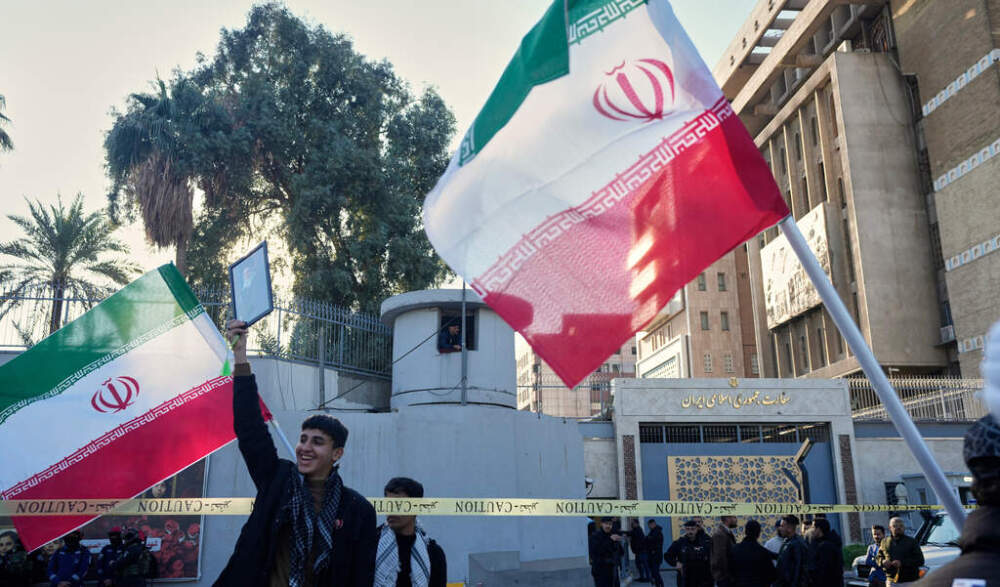 caption: Iraqi protesters gather in front of the Iranian Embassy, during a rally to show solidarity with Iran and oppose the U.S. threats of a military strike, in Baghdad, Iraq, Friday, Jan. 16, 2026. (AP Photo/Hadi Mizban)