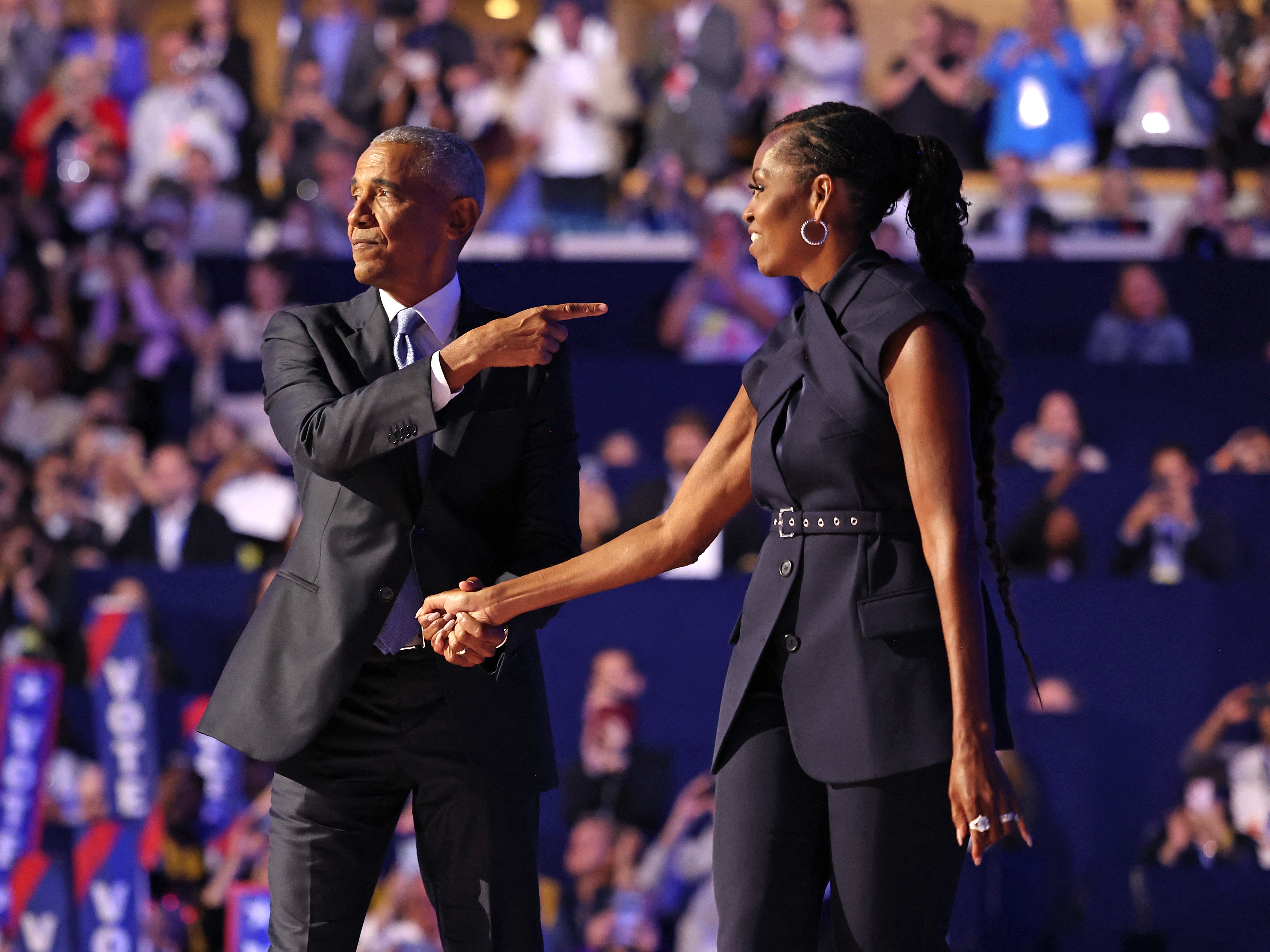 caption: Former First Lady Michelle Obama (R) introduces former President Barack Obama on the second day of the Democratic National Convention at the United Center in Chicago, Illinois, on August 20, 2024. 
