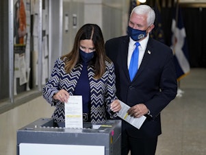 caption: Vice President Pence and his wife, Karen, cast their ballots Friday during early voting in Indianapolis.