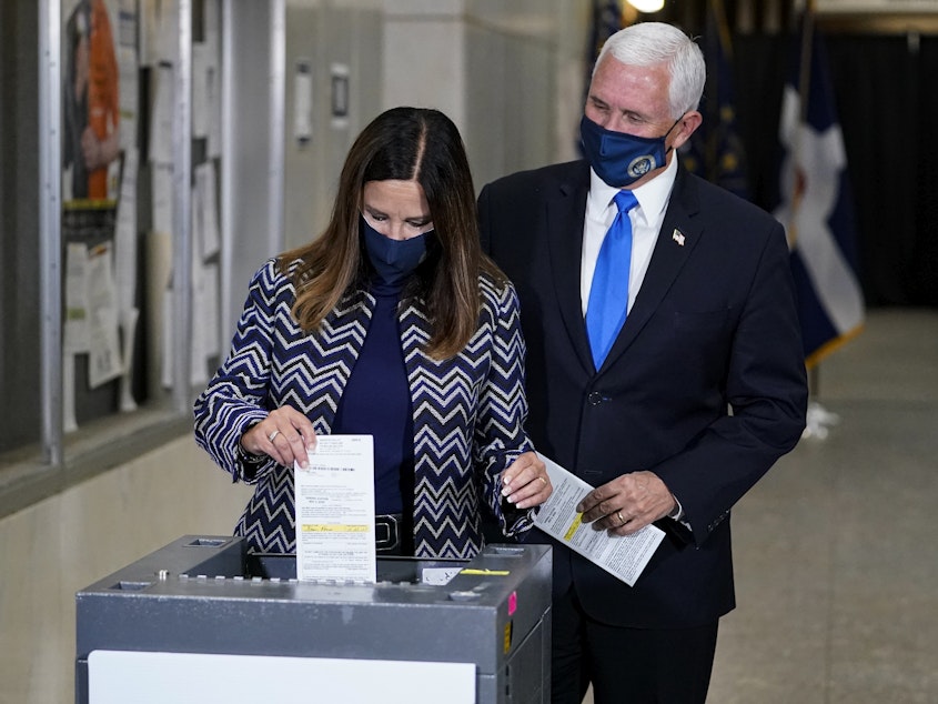 caption: Vice President Pence and his wife, Karen, cast their ballots Friday during early voting in Indianapolis.