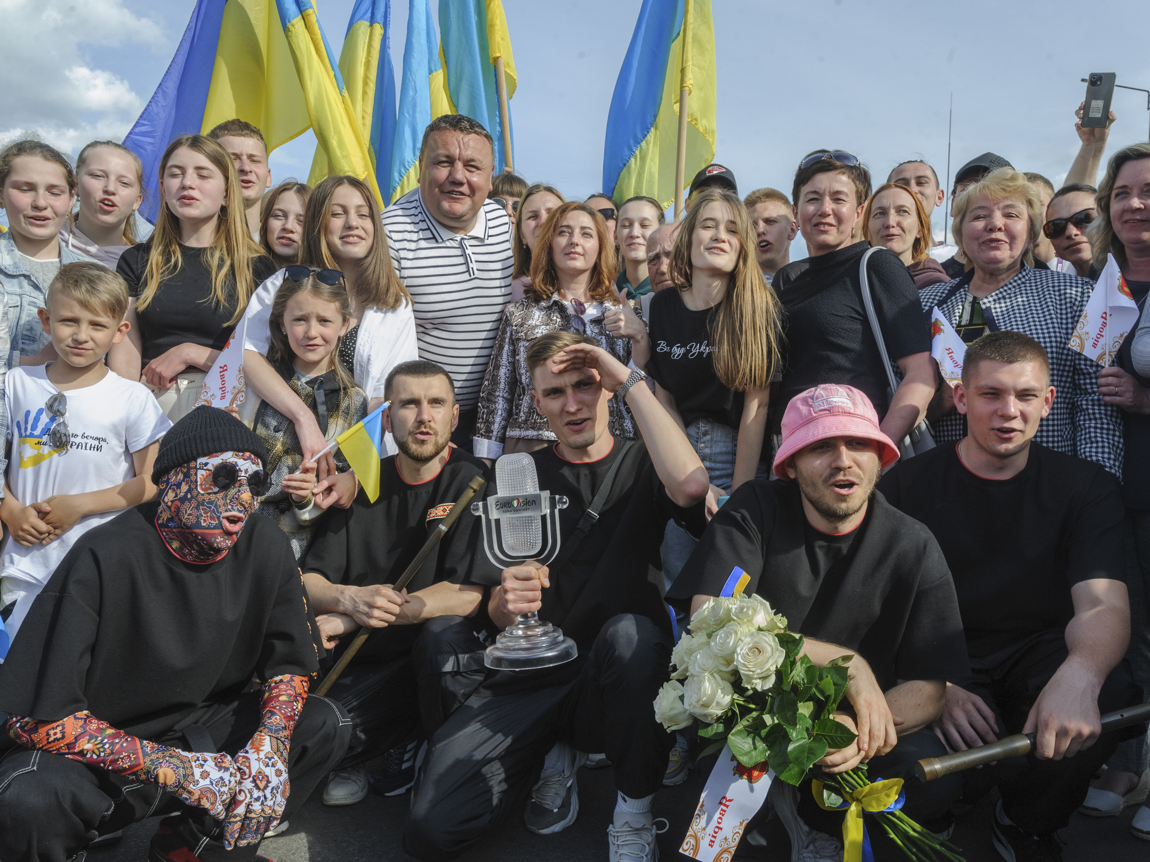 caption: Ukraine's Kalush Orchestra, winners of the Eurovision Song Contest, pose with their trophy in Krakovets, at the Ukraine border with Poland, on May 16. The U.K., which placed second, is in talks to host next year's event instead of Ukraine due to the war.