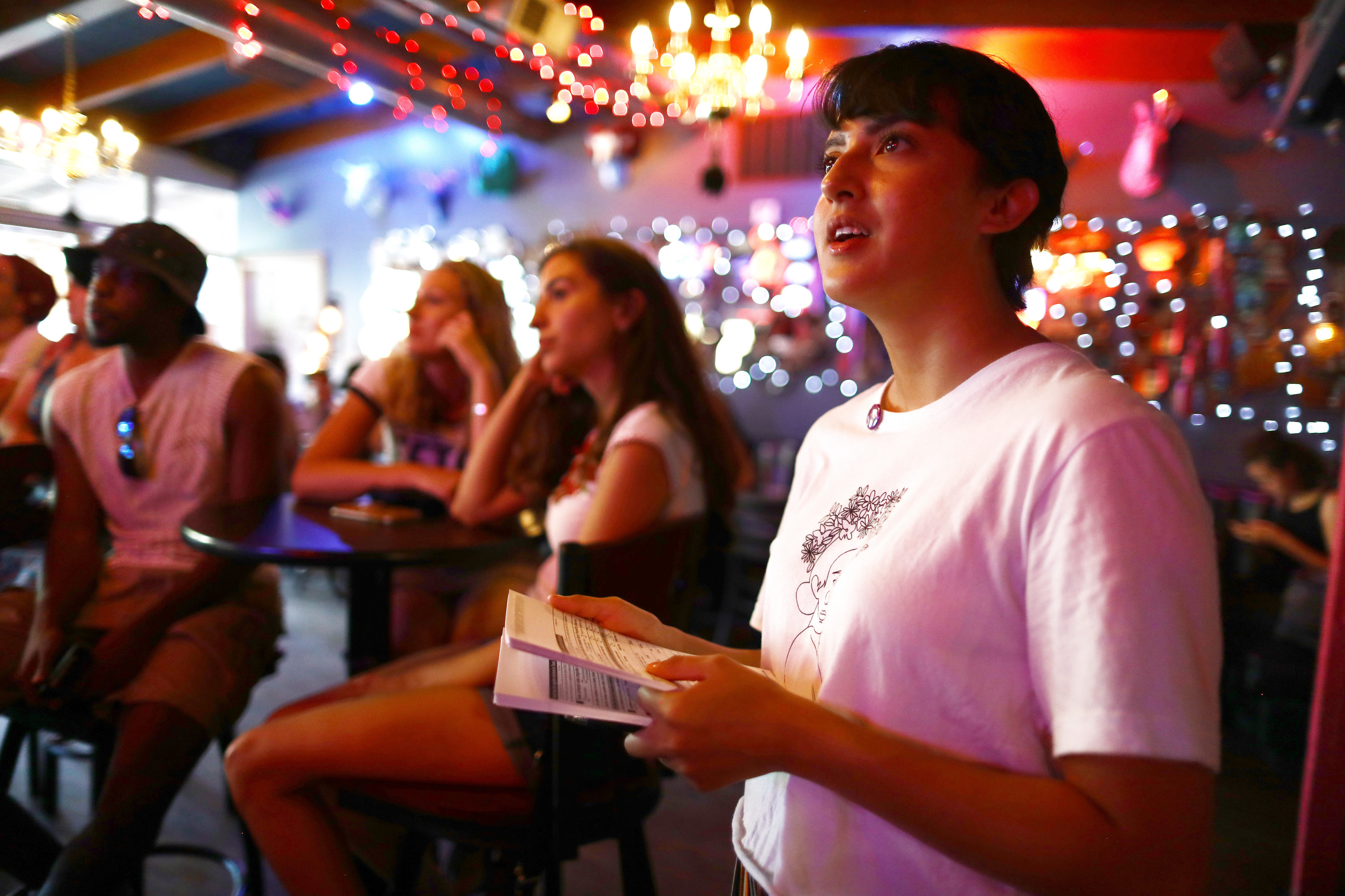 caption: Immigration rights activist Angel Ulloa views a Democratic debate broadcast during a debate watch party on June 26, 2019 in El Paso, Texas. (Mario Tama/Getty Images)