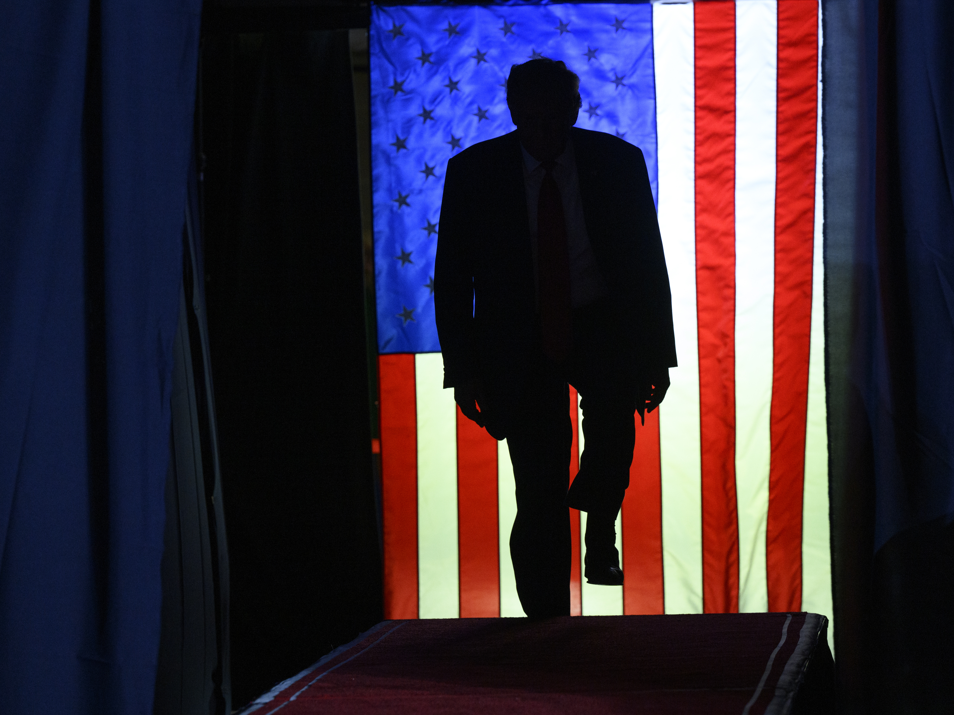 caption: Donald Trump enters a political rally in Erie, Pennsylvania in late July.
