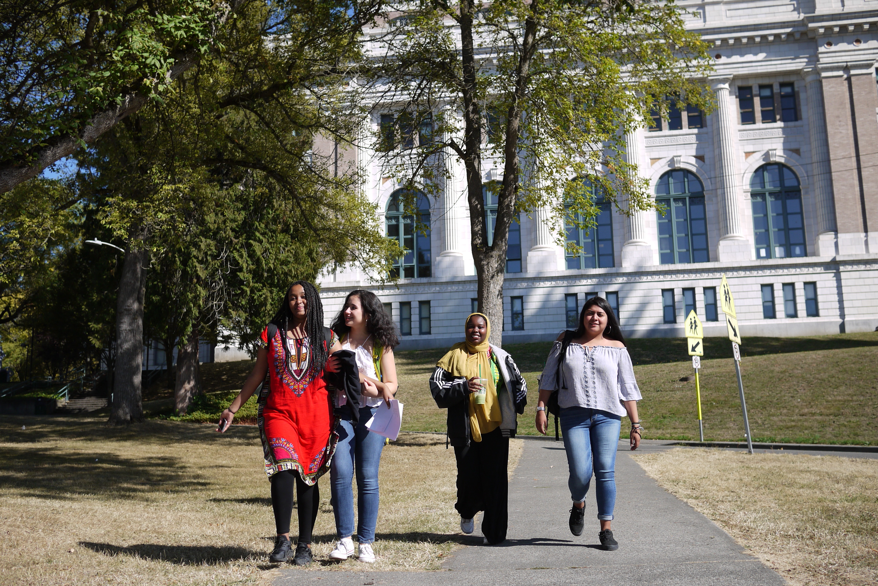 caption: Dulce Palma, right, and classmates join a walkout to support undocumented students.