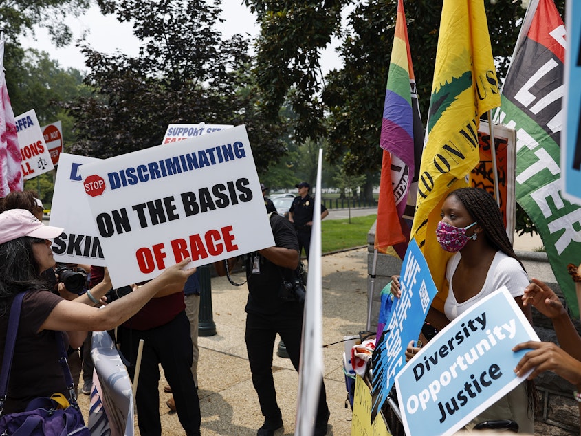 caption: Protesters for and against affirmative action demonstrate on Capitol Hill on Thursday. The Supreme Court ruled that race-conscious admissions programs at Harvard University and the University of North Carolina are unconstitutional.
