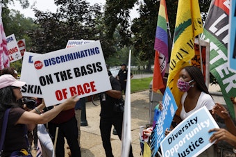 caption: Protesters for and against affirmative action demonstrate on Capitol Hill on Thursday. The Supreme Court ruled that race-conscious admissions programs at Harvard University and the University of North Carolina are unconstitutional.