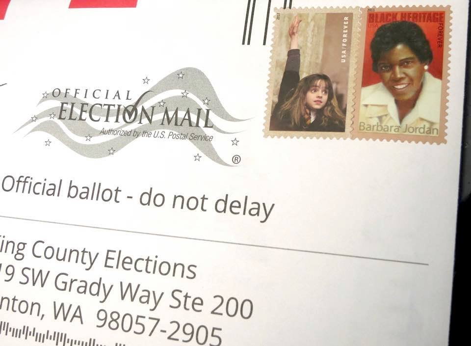 caption: King County wants to reduce any barrier to voting and is experimenting with pre-paid postage for envelopes. 