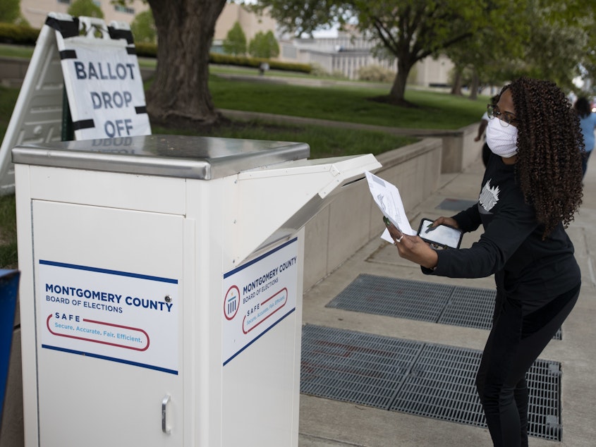 caption: An Ohio voter drops off her ballot at the Board of Elections in Dayton earlier this week. Legal fights around mail-in voting are heating up as states turn to the practice amid the coronavirus pandemic.