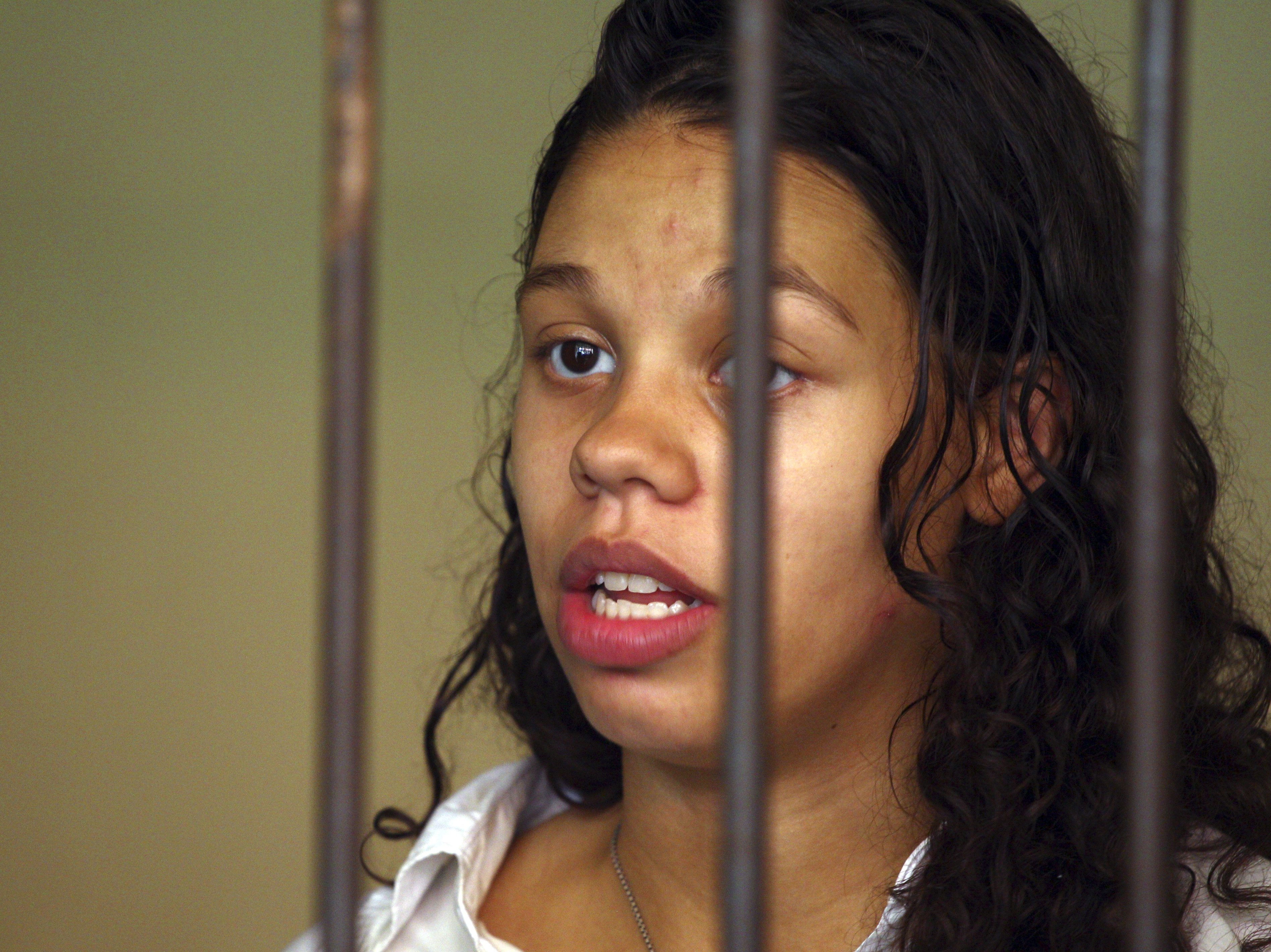 caption: Heather Mack from Chicago, Ill., stands inside a cell before a trial in Bali, Indonesia, on March 11, 2015. Mack, who pleaded guilty to helping kill her own mother and stuffing the body in a suitcase during a luxury vacation in Bali, was sentenced by a federal judge, Wednesday to 26 years in prison.