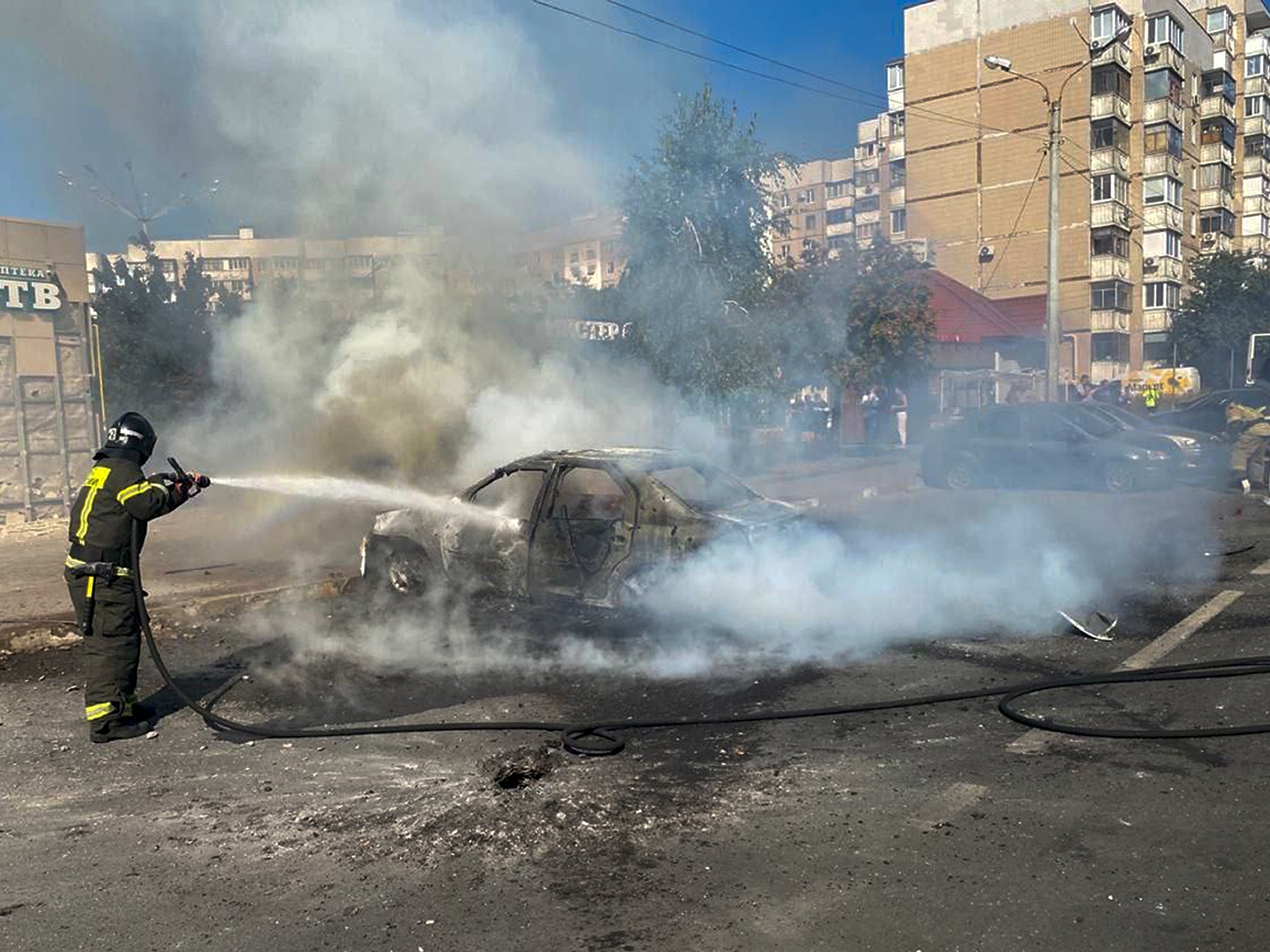 caption: In this photo released by Belgorod regional governor Vyacheslav Gladkov's Telegram channel on Sunday, Sept. 1, 2024, firefighters extinguish a burning car in the courtyard of an apartment building after a missile attack by the Armed Forces of Ukraine on the city of Belgorod and the Belgorod region of Russia.