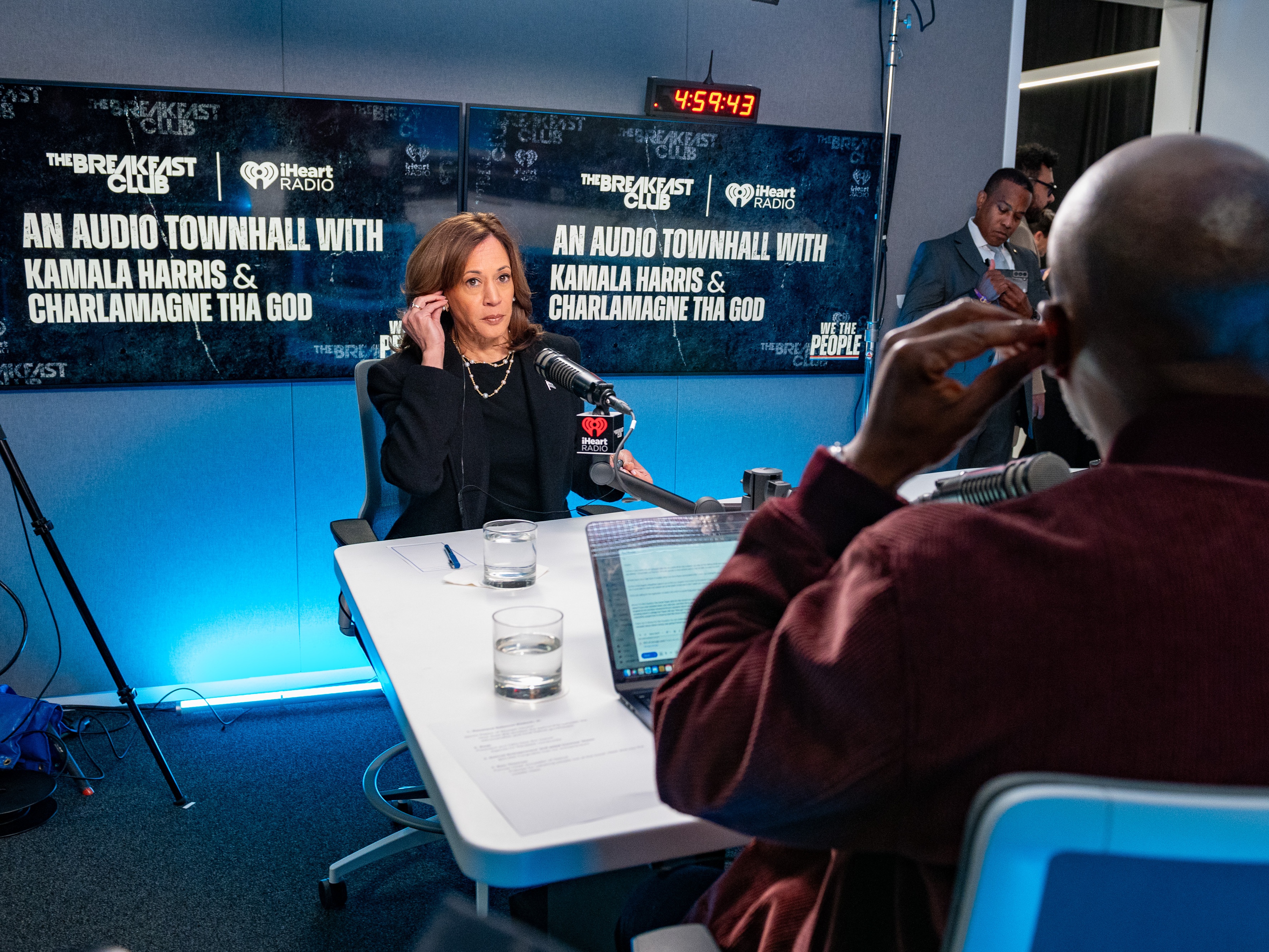 caption: Vice President Harris prepares to speak with Charlamagne Tha God before "We The People: An Audio Townhall With Kamala Harris and Charlamagne Tha God" in Detroit on Tuesday.