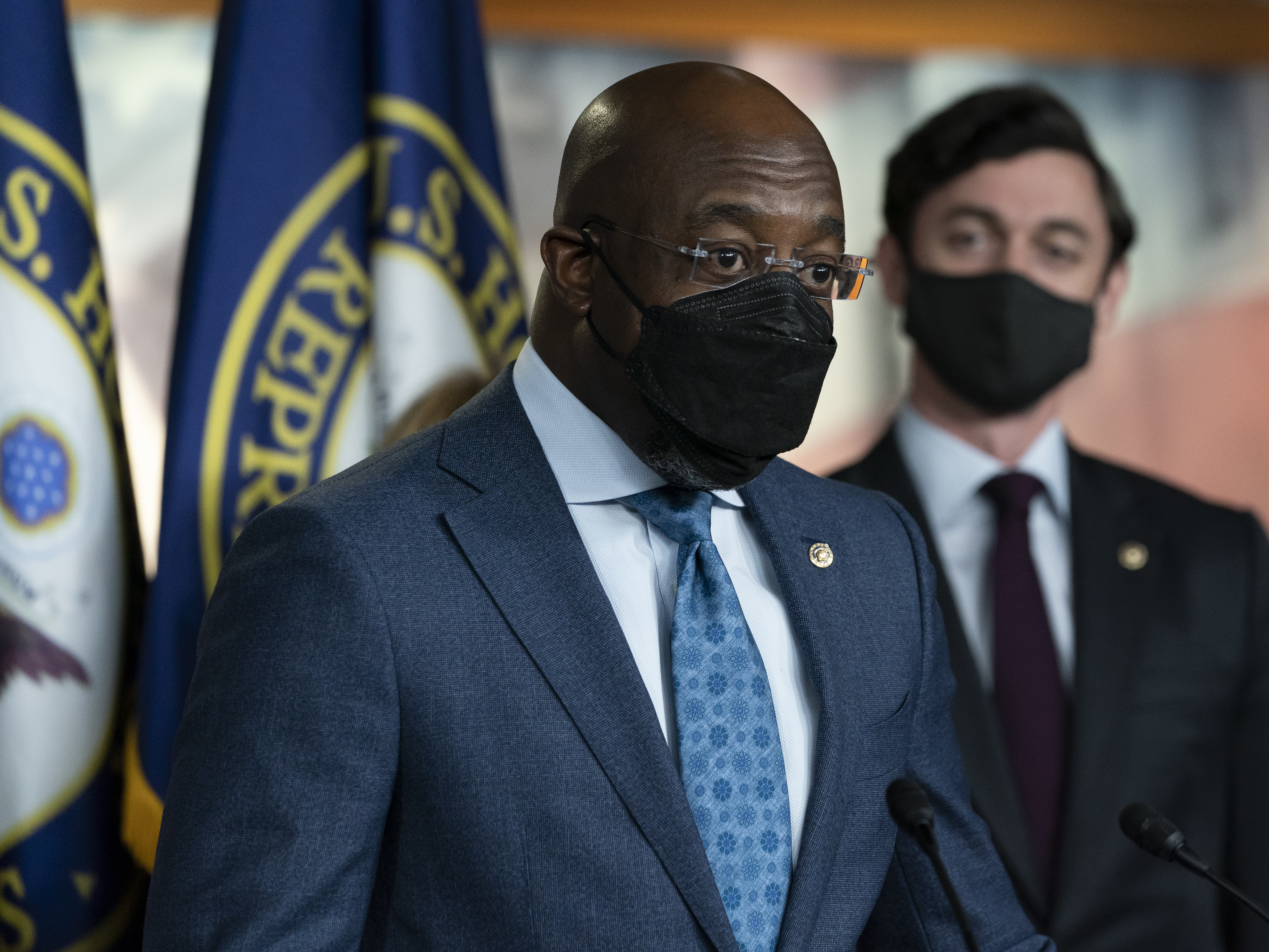 caption: Sen. Raphael Warnock, D-Ga., left, accompanied by Sen. Jon Ossoff, D-Ga., speaks during a news conference, before the vote on the Democrat's $1.9 trillion COVID-19 relief bill on March 10, 2021.
