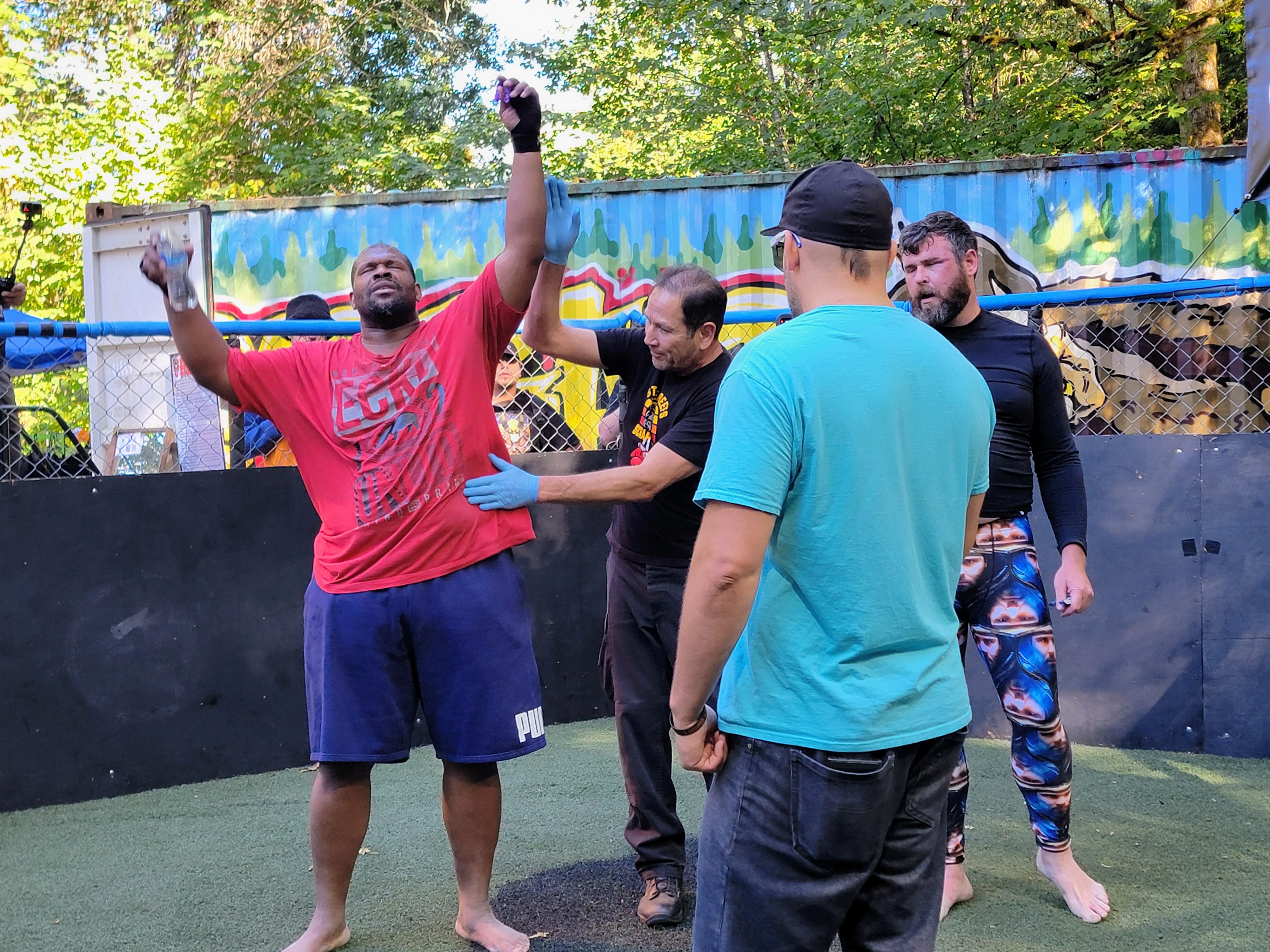 caption: Curtis Muldrow (left) celebrates a win in The Scrapyard near Gig Harbor on Saturday, Sept. 20, 2025.