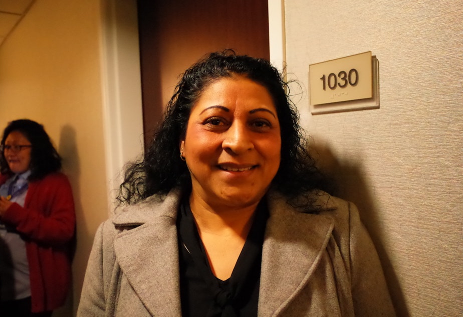 caption: Maria Estrada, in a hallway at the Springfield Suites hotel. She words at the Hilton Seattle.