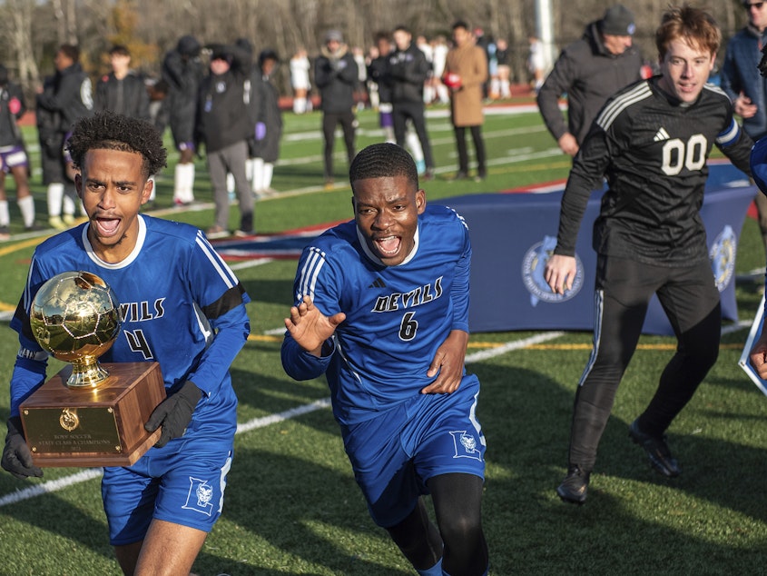 caption: When the Lewiston High School Blue Devils boys' soccer team won a state championship, they brought joy to a community that was rocked by a mass shooting in late October.