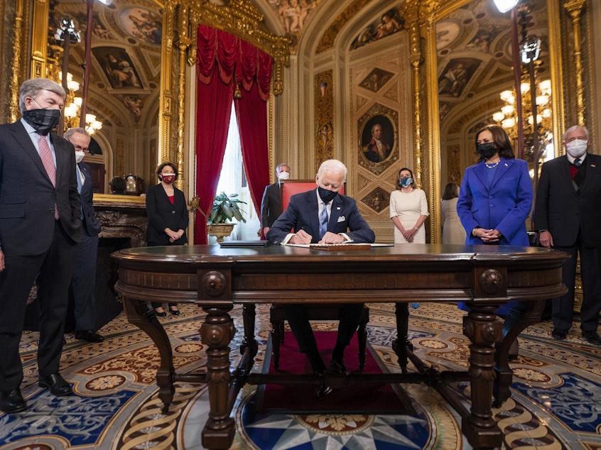 caption: President Joe Biden signs three documents including an inauguration declaration, cabinet nominations and sub-cabinet nominations in the President's Room at the US Capitol after the inauguration ceremony, Wednesday.