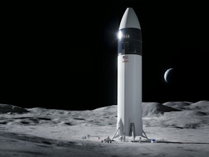 caption: Illustration of SpaceX Starship human lander design that will carry the first NASA astronauts to the surface of the moon under the Artemis program.