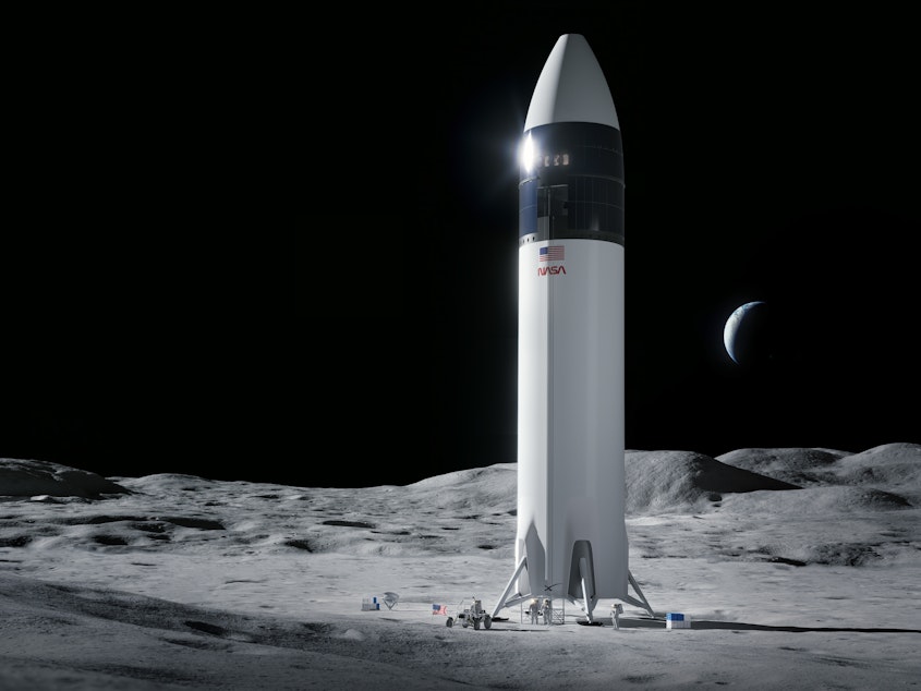 caption: Illustration of SpaceX Starship human lander design that will carry the first NASA astronauts to the surface of the moon under the Artemis program.