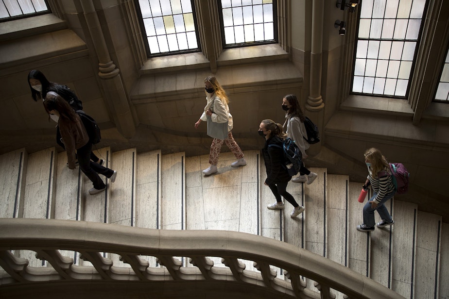 caption: University of Washington students walk up a set of stairs toward the Suzzalo Library on the first day of school, Wednesday, September 29, 2021, on the University of Washington campus in Seattle.