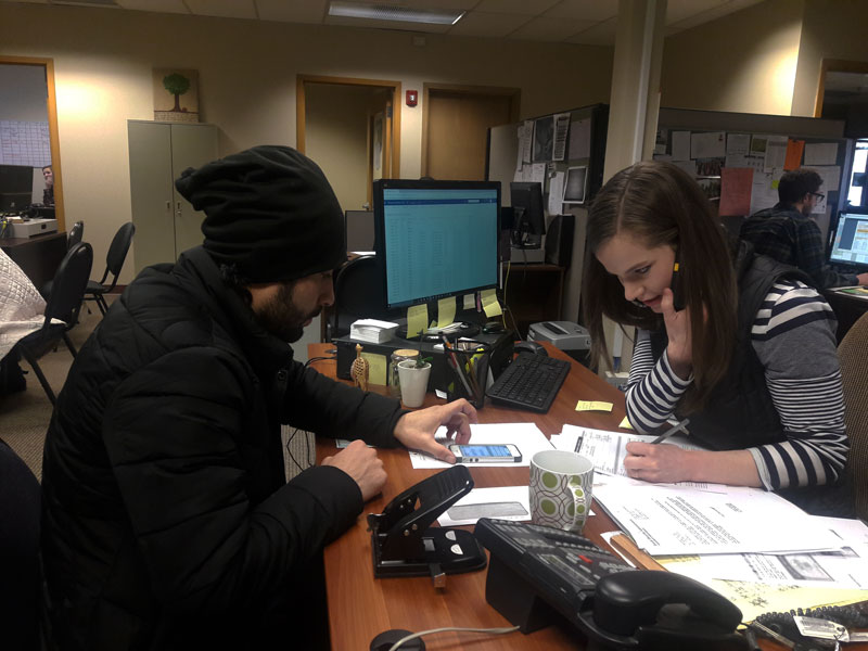 caption: Marwal Frotan, left, meets with his caseworker at World Relief Seattle in Kent. He and his family came here from Afghanistan last December.