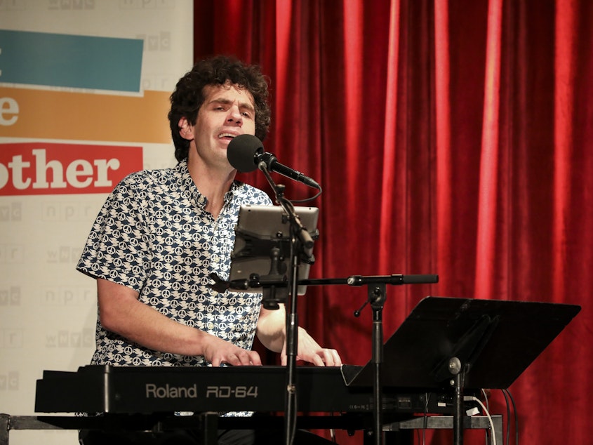 caption: Guest musician Julian Velard leads a music parody game on Ask Me Another at the Bell House in Brooklyn, New York.