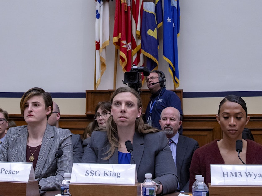 caption: Army Capt. Jennifer Peace, Army Staff Sgt. Patricia King (center) and Navy Petty Officer 3rd Class Akira Wyatt attend a hearing on Transgender Service Policy on Capitol Hill in 2019. King and other trans troops have long fought for the right to serve openly prior to Trump's ban, and she hopes there is more legislation to follow Biden's repeal to ensure something like that does not happen again.