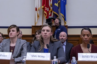caption: Army Capt. Jennifer Peace, Army Staff Sgt. Patricia King (center) and Navy Petty Officer 3rd Class Akira Wyatt attend a hearing on Transgender Service Policy on Capitol Hill in 2019. King and other trans troops have long fought for the right to serve openly prior to Trump's ban, and she hopes there is more legislation to follow Biden's repeal to ensure something like that does not happen again.