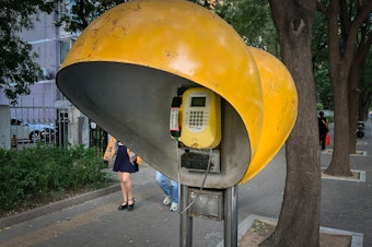 caption: In July, this Beijing payphone began ringing. Who was calling?