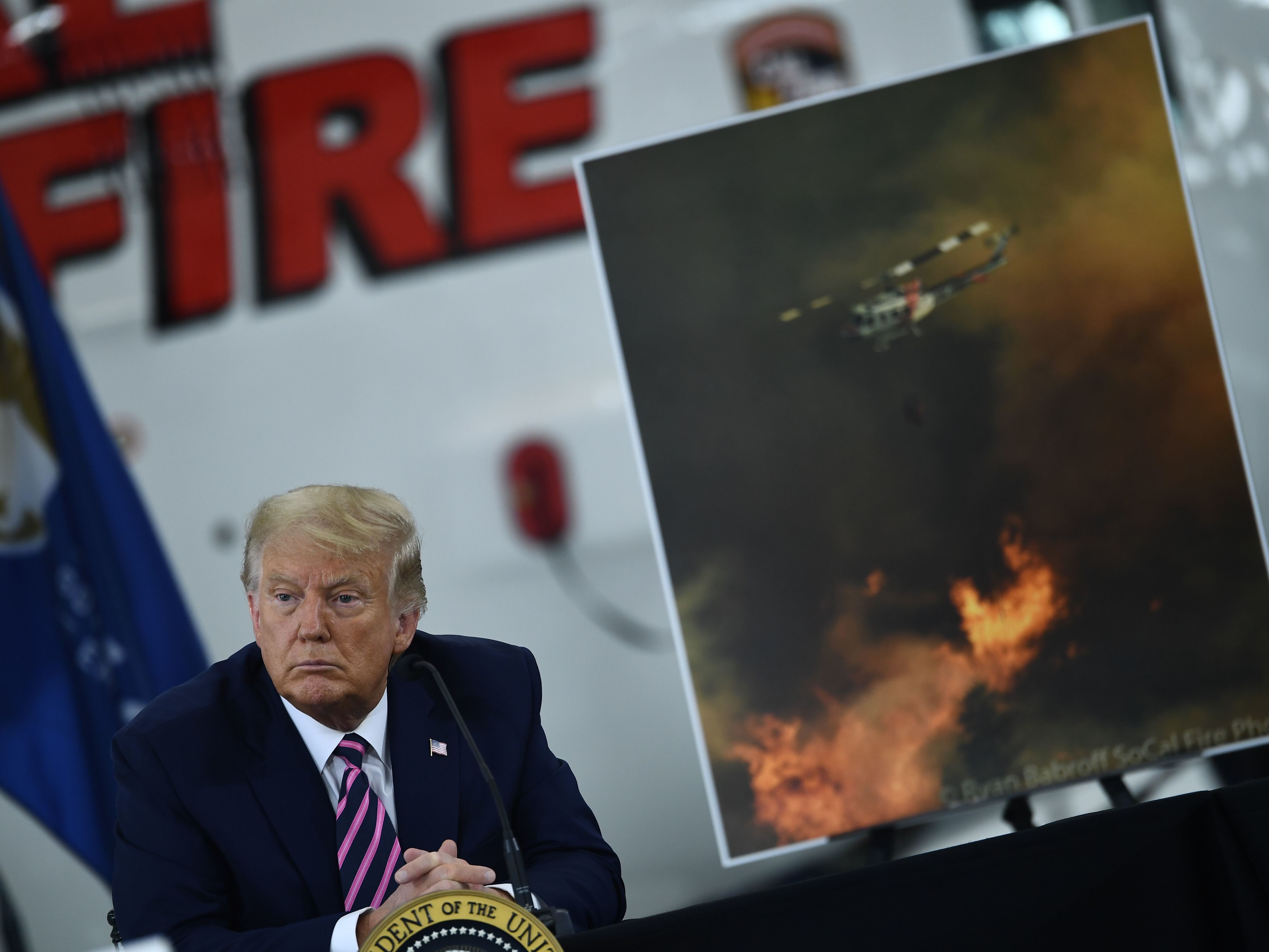 caption: President Trump speaks Monday during a briefing on wildfires in McClellan Park, Calif.