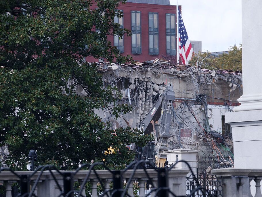 caption: The facade of the East Wing of the White House is demolished by work crews on Wednesday. The demolition is part of President Trump's plan to build a ballroom.