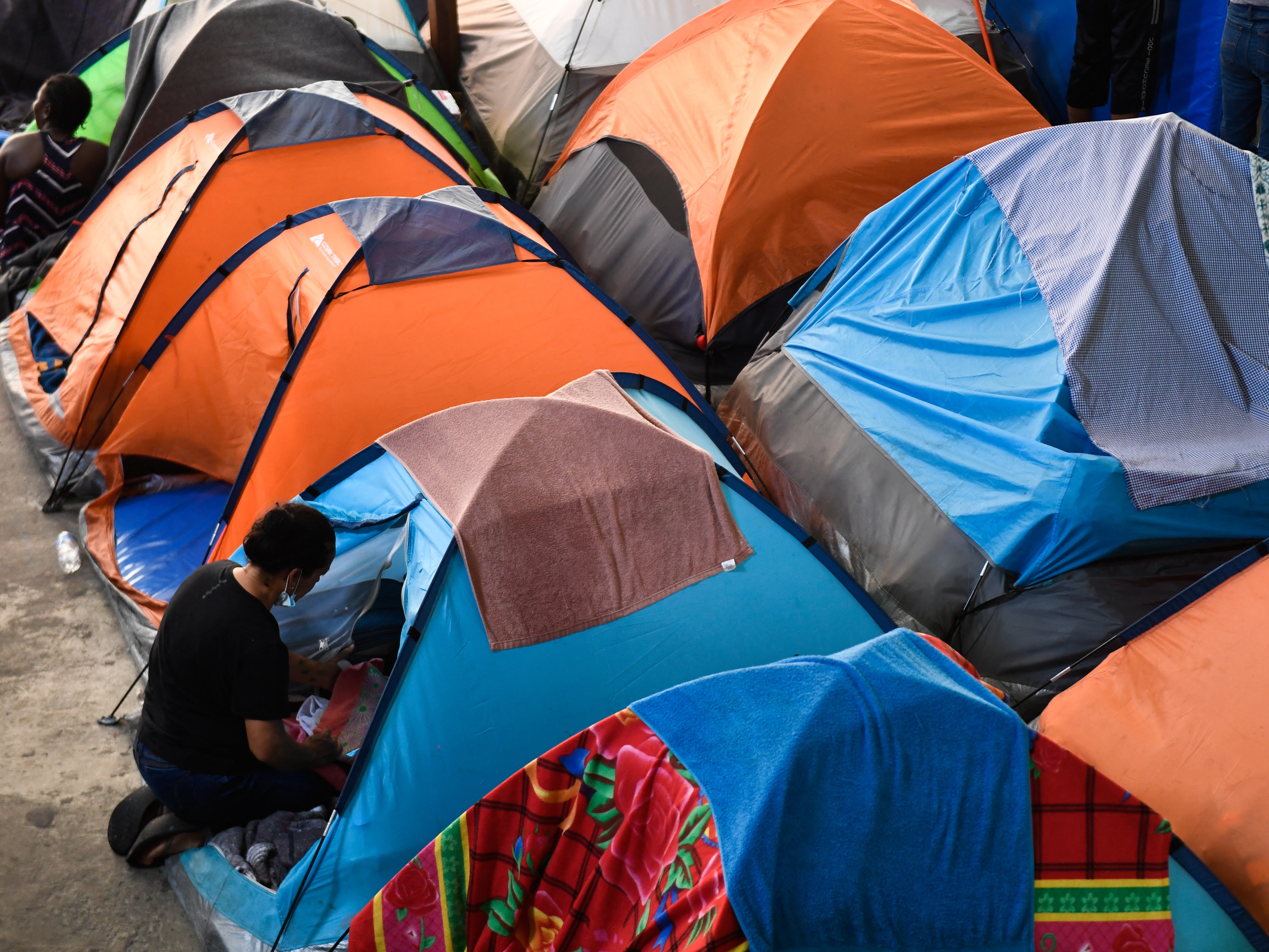 caption: Migrant families live in tents at the Movimiento Juventud 2000 shelter in Tijuana, Mexico, back in April 2022, when the U.S. border restrictions known as Title 42 and "Remain in Mexico" were still in effect.