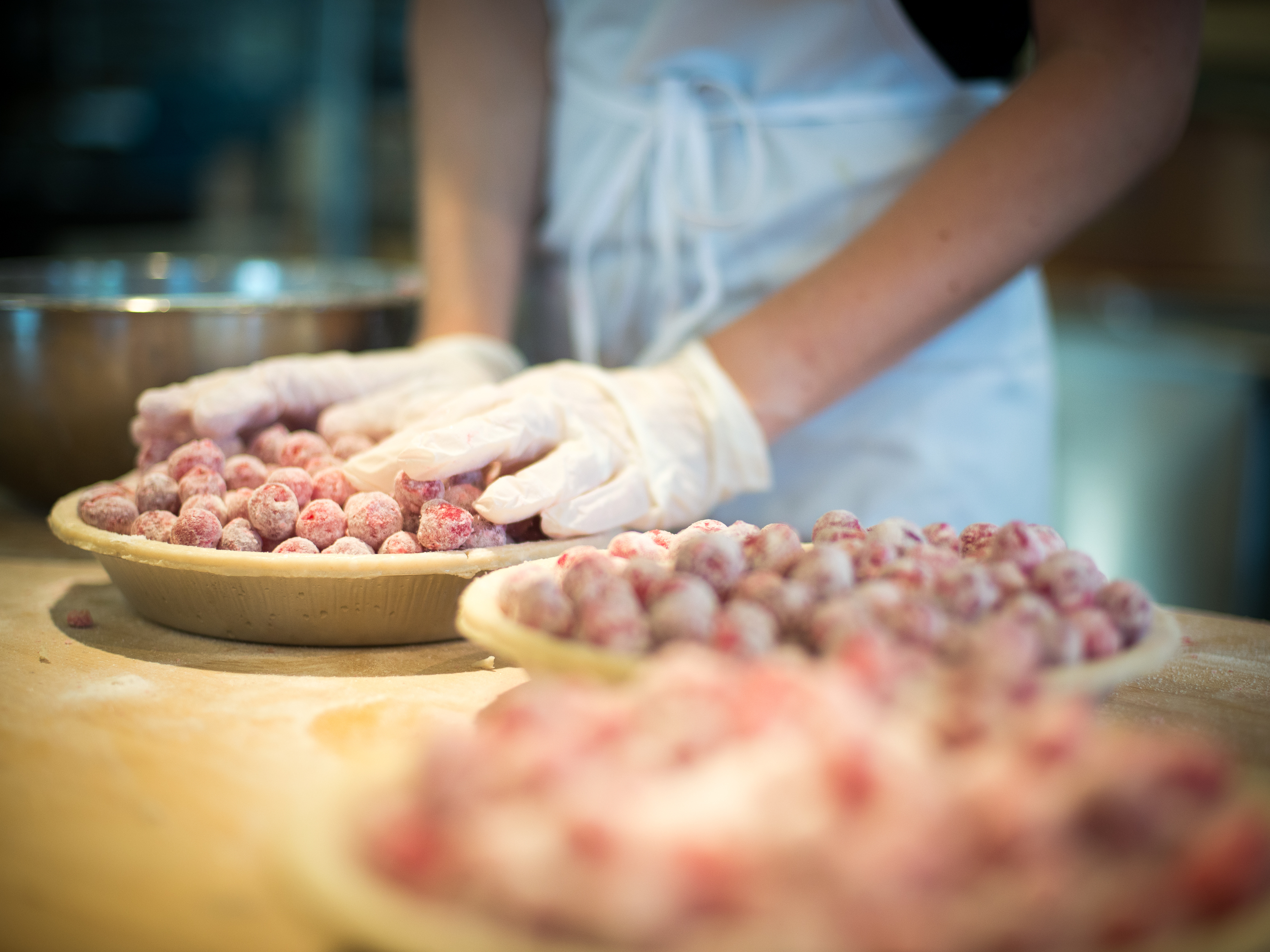 caption: An employee at Grand Traverse Pie Co. in Michigan makes cherry pies. The company has been shipping pies since 1998, when people still had to phone in their orders.