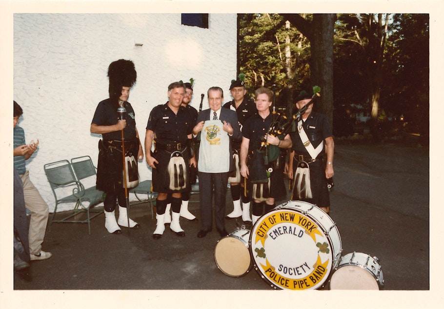 caption: The City of New York Police Department Emerald Society pipe and drum band play for former President Richard Nixon. “They came by one day and asked me if they could play something for him,” Endicott, former Secret Service agent, said. “I was retiring in three years, I asked them to wait until then and they said ‘yeah.’” Endicott recalled putting the bearskin hat on and marching around. “It was a lot of fun,” he said. 