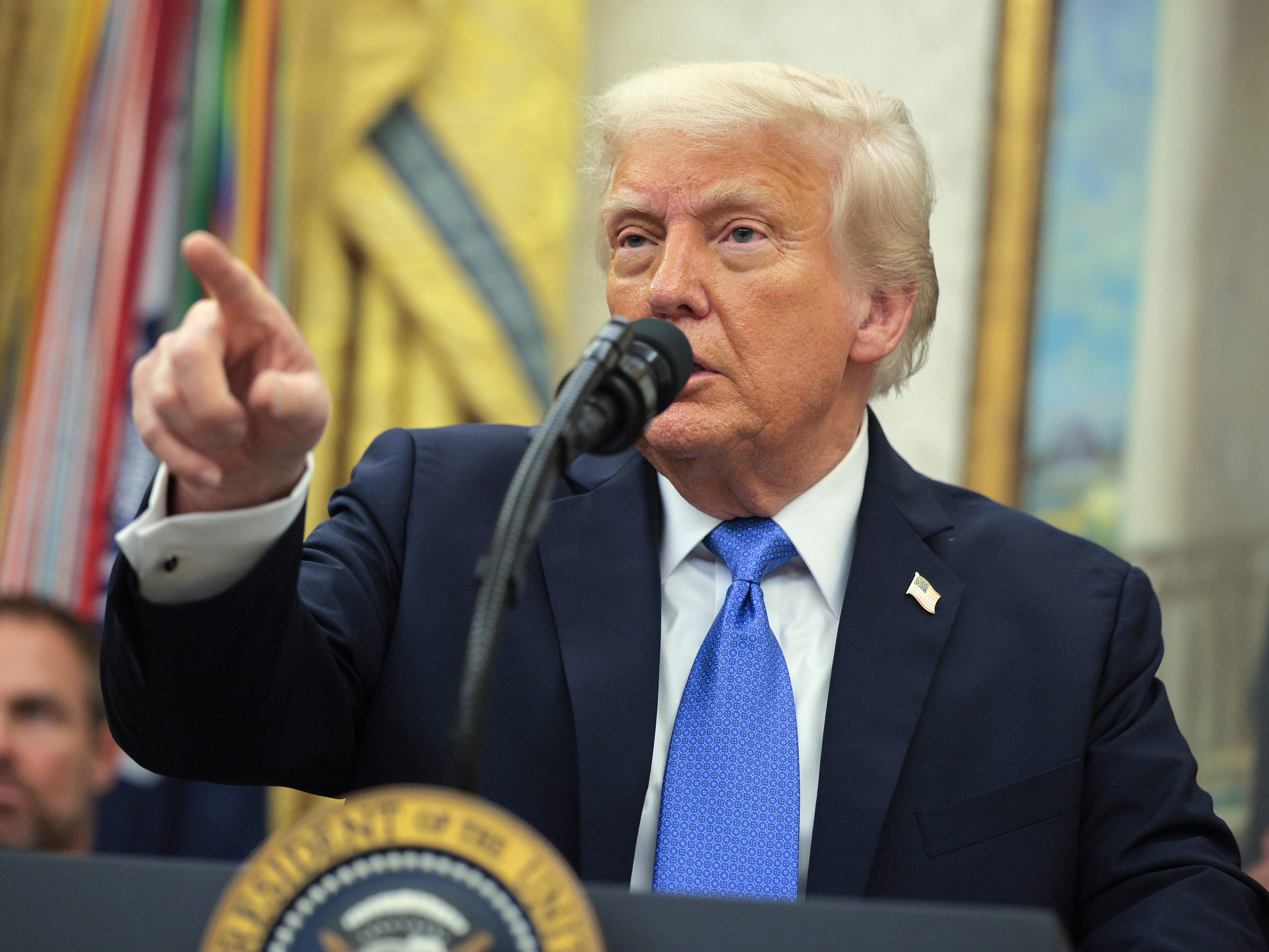 caption: President Trump takes questions from reporters at an event in the Oval Office on May 19, 2025.