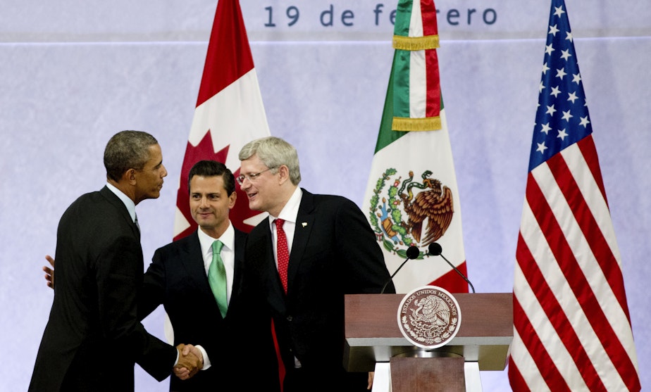 caption: President Barack Obama, left, Mexico's President Enrique Pena Nieto, center, and the Prime Minister of Canada, Stephen Harper, shake hands at the end of a news conference concluding the North American Leaders Summit in Toluca, Mexico.
