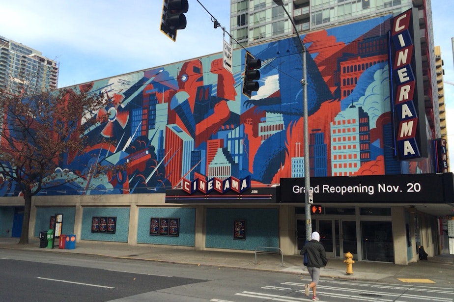 caption: Cinerama's mural by Seattle design studio Invisible Creatures features fictitious movie characters and scenes, as seen when the theater was preparing to reopen in 2014 after an extensive renovation to update the theater to modern standards. 