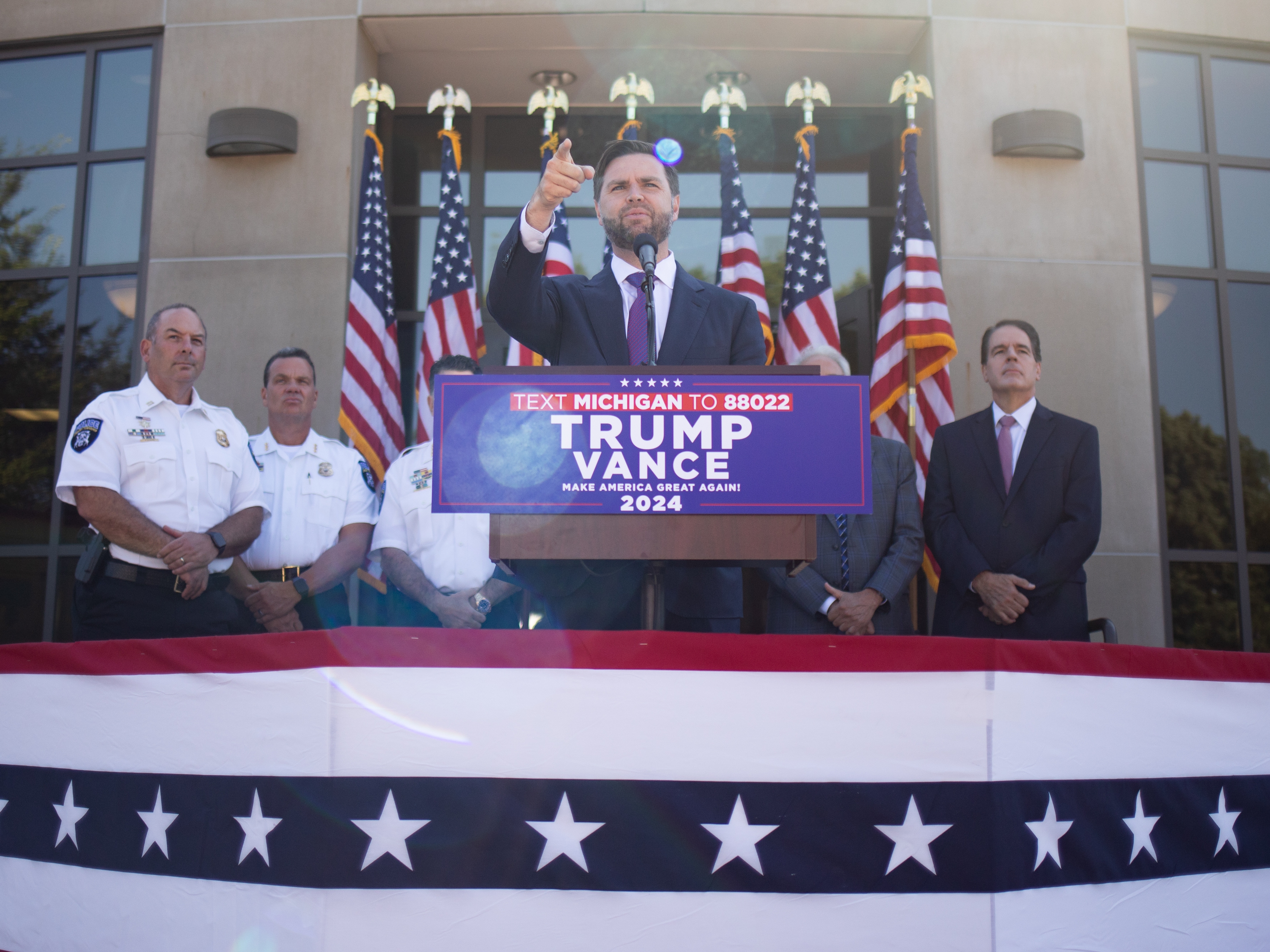 caption: Republican vice presidential nominee JD Vance, a U.S. senator from Ohio, speaks during a press conference at the Shelby Township Police Department on Wednesday in Shelby, Mich.